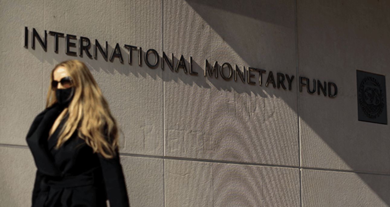 Woman walks past International Monetary Fund headquarters (IMF) building in Washington, DC. (File/MANDEL NGAN/AFP)